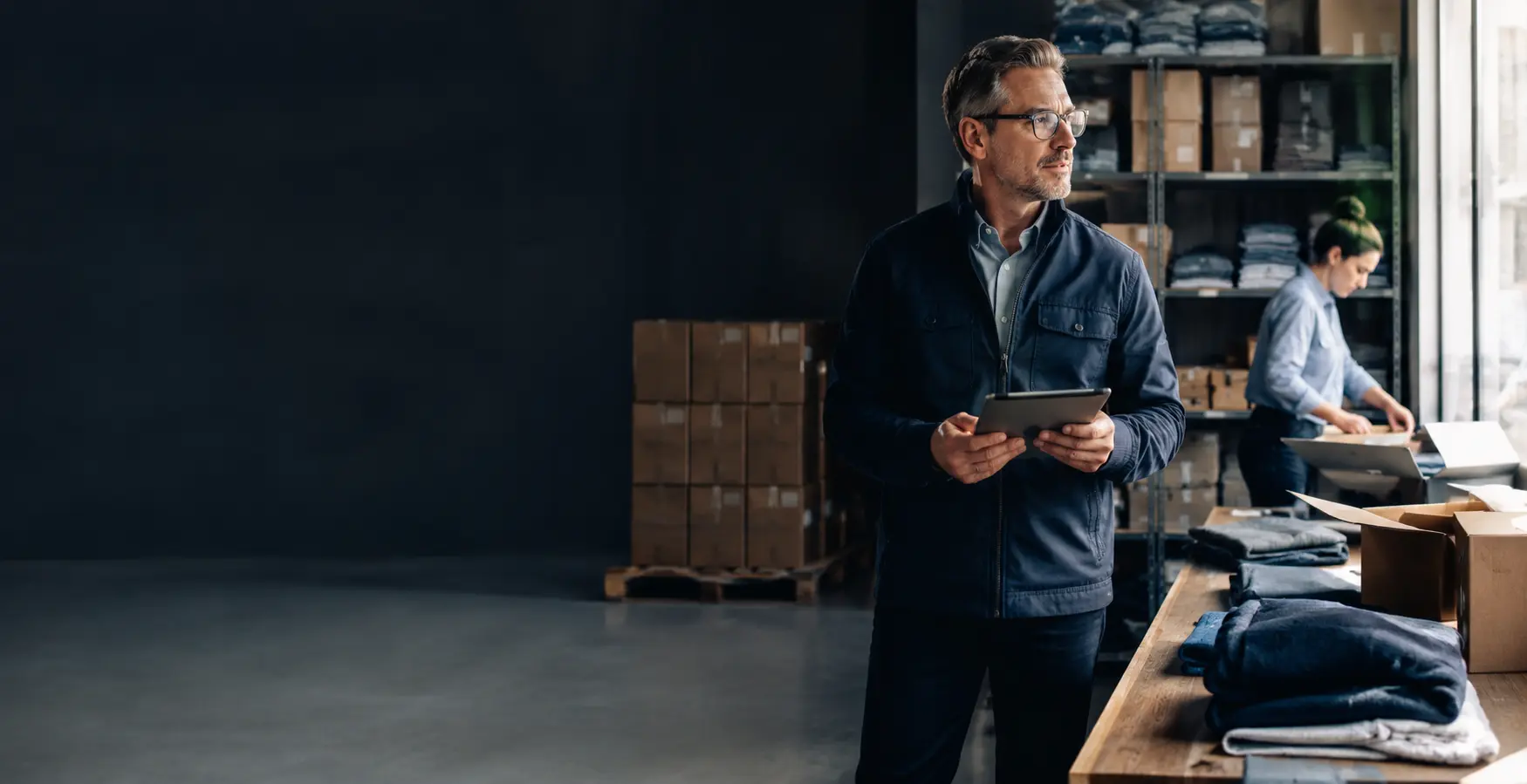 A business owner overseeing seasonal inventory arriving at a stockroom